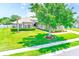 Beautiful single-Gathering home boasts a lush green lawn, mature tree, and manicured landscaping at 2250 Mountain Ash Way, New Port Richey, FL 34655