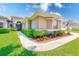 Well-maintained home featuring manicured landscaping and lush green lawn with a sidewalk at 2250 Mountain Ash Way, New Port Richey, FL 34655