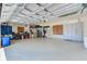 Spacious garage with overhead racks and storage offers ample room for vehicles and tools at 2250 Mountain Ash Way, New Port Richey, FL 34655