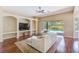 Comfortable living room with built-ins, a ceiling fan, and sliding glass doors to the patio at 2250 Mountain Ash Way, New Port Richey, FL 34655