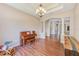 Inviting living room featuring a piano, wood floors, and elegant chandelier at 2250 Mountain Ash Way, New Port Richey, FL 34655