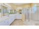 The main bathroom features double sinks, shower, and tub at 2250 Mountain Ash Way, New Port Richey, FL 34655