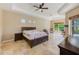 Spacious main bedroom features a ceiling fan, tile floors, and plenty of natural light at 2250 Mountain Ash Way, New Port Richey, FL 34655