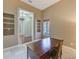 Bright office space features built-in shelves and desk, and view to the entry of the home at 2250 Mountain Ash Way, New Port Richey, FL 34655