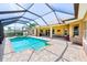 A covered and screened-in pool and spa features brick paver patio at 2250 Mountain Ash Way, New Port Richey, FL 34655