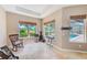 Bright sitting area with natural lighting from the large windows and tile floors at 2250 Mountain Ash Way, New Port Richey, FL 34655