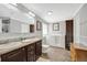 Well-lit bathroom features double sinks, stylish cabinetry, a soaking tub, and elegant finishes for a spa-like experience at 262 S Port Royal Ln, Apollo Beach, FL 33572