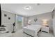 Cozy bedroom with a white bed, gray walls and lots of natural light from the window at 262 S Port Royal Ln, Apollo Beach, FL 33572