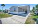 Charming home featuring gray siding, white trim and a covered carport for convenient parking and protection from the elements at 262 S Port Royal Ln, Apollo Beach, FL 33572