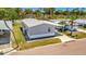 Cozy grey home featuring manicured landscaping, a carport, and a charming, well-maintained exterior at 262 S Port Royal Ln, Apollo Beach, FL 33572
