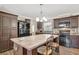 Eat-in kitchen with large island, bar seating, dark cabinetry and black appliances at 262 S Port Royal Ln, Apollo Beach, FL 33572