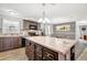 Spacious kitchen showcasing a large island with dark wood cabinetry and a decorative chandelier at 262 S Port Royal Ln, Apollo Beach, FL 33572