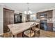 Eat-in kitchen with large island, bar seating, dark cabinetry and black appliances at 262 S Port Royal Ln, Apollo Beach, FL 33572