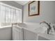 Brightly lit walk-in tub with large window and floral art at 262 S Port Royal Ln, Apollo Beach, FL 33572