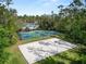 Aerial showcasing the sand volleyball and basketball courts among the verdant community landscape at 27549 Stonecreek Way, Wesley Chapel, FL 33544