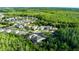 Aerial view showcasing the community's layout, featuring houses nestled among lush greenery and winding roads at 27549 Stonecreek Way, Wesley Chapel, FL 33544