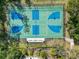 Aerial view of a community basketball court with blue and green painted surfaces and seating at 27549 Stonecreek Way, Wesley Chapel, FL 33544