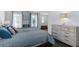 Inviting bedroom with stylish decor, wood-look flooring, and plenty of natural light at 27549 Stonecreek Way, Wesley Chapel, FL 33544