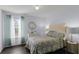 Calm bedroom with a floral patterned comforter set and natural light through the window at 27549 Stonecreek Way, Wesley Chapel, FL 33544