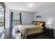 Cozy bedroom with a window view, queen bed, and dark wood flooring at 27549 Stonecreek Way, Wesley Chapel, FL 33544