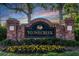 Stonecreek community entrance sign with brick columns, manicured landscaping, and a welcoming atmosphere at 27549 Stonecreek Way, Wesley Chapel, FL 33544