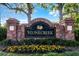 Stonecreek community entrance sign featuring brick pillars and colorful flower bed at 27549 Stonecreek Way, Wesley Chapel, FL 33544