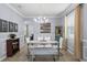Elegant dining room with modern chandelier, ample seating, wainscotting, and stylish decor at 27549 Stonecreek Way, Wesley Chapel, FL 33544