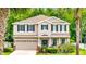 Charming two-story home with a well-manicured lawn, black shutters, and a welcoming front porch at 27549 Stonecreek Way, Wesley Chapel, FL 33544