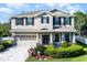 Charming two-story home features a well-maintained yard, neutral paint, and a two car garage at 27549 Stonecreek Way, Wesley Chapel, FL 33544