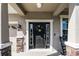 Inviting front door with decorative wreath and sidelights, enhanced by stone accents at 27549 Stonecreek Way, Wesley Chapel, FL 33544
