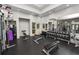 Community gym with modern exercise equipment and mirrored walls at 27549 Stonecreek Way, Wesley Chapel, FL 33544