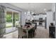 Open-concept kitchen and dining area with a sliding glass door to outdoor patio at 27549 Stonecreek Way, Wesley Chapel, FL 33544