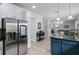 Kitchen with stainless steel refrigerator, adjacent dining area, and neutral paint at 27549 Stonecreek Way, Wesley Chapel, FL 33544