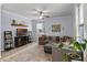 Comfortable living room featuring a sectional sofa, ceiling fan, and decorative shelves at 27549 Stonecreek Way, Wesley Chapel, FL 33544