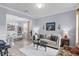Inviting living room featuring neutral tones, wainscotting, and adjacent dining space with ample natural light at 27549 Stonecreek Way, Wesley Chapel, FL 33544
