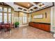 Community lounge area with high ceilings, elegant decor, and a dining set at 27549 Stonecreek Way, Wesley Chapel, FL 33544