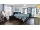 Bedroom with natural light, hardwood floors, king bed, and stylish decor for a modern look at 27549 Stonecreek Way, Wesley Chapel, FL 33544