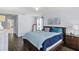 Bedroom with natural light, hardwood floors, king bed, and stylish decor for a modern look at 27549 Stonecreek Way, Wesley Chapel, FL 33544