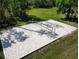 Aerial shot of a sandy volleyball court with net in a green grassy area at 27549 Stonecreek Way, Wesley Chapel, FL 33544