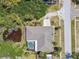 An aerial view showcases the layout of the property, including the pool, pond, deck, and surrounding greenery at 284 Peninsula Ave, Tarpon Springs, FL 34689
