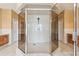 Bathroom with glass shower, tile flooring, and dual vanities at 284 Peninsula Ave, Tarpon Springs, FL 34689