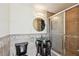 Bathroom featuring a vessel sink, accent lighting, round mirror and glass shower at 284 Peninsula Ave, Tarpon Springs, FL 34689