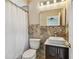 Bathroom featuring tiled walls, a stand alone sink and a framed mirror at 284 Peninsula Ave, Tarpon Springs, FL 34689