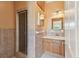 Bathroom showcasing a tiled shower, vanity with sink, and a well-lit mirror, enhancing the functionality at 284 Peninsula Ave, Tarpon Springs, FL 34689