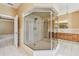 Bathroom with glass shower, tile flooring, and dual vanities at 284 Peninsula Ave, Tarpon Springs, FL 34689