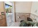 Bathroom featuring tiled walls and a glass vessel sink, with a view of the outdoor pool area at 284 Peninsula Ave, Tarpon Springs, FL 34689