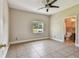 Bedroom with tile flooring and access to a bathroom at 284 Peninsula Ave, Tarpon Springs, FL 34689