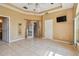 Bright primary bedroom with tile floors, tray ceiling, and ensuite bathroom at 284 Peninsula Ave, Tarpon Springs, FL 34689