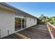 Spacious wooden deck with sliding glass doors providing access to the home's interior at 284 Peninsula Ave, Tarpon Springs, FL 34689