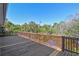 Large wooden deck overlooking a serene pond offers an ideal setting for relaxation and enjoying nature's beauty at 284 Peninsula Ave, Tarpon Springs, FL 34689